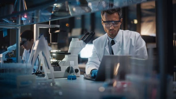 Scientist working with a microscope in the laboratory